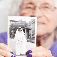 woman holding an old photo