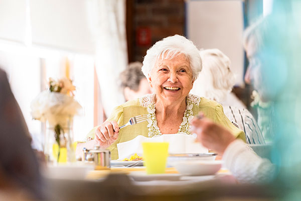 smiling senior woman at dinner